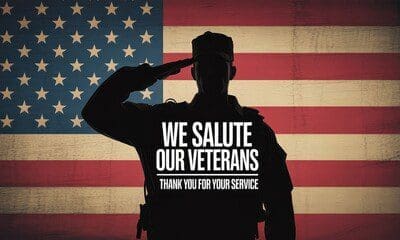 A silhouetted soldier salutes in front of a large American flag with the text "We Salute Our Veterans. Thank You for Your Service.