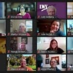 A screenshot of a virtual meeting with 25 people smiling, some holding up signs or notebooks, each shown in individual video call windows against various backgrounds.